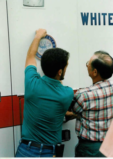 Mel Lantz and Mark Beyer put the state Voluntary Ambulance Service Certification emblem on the ambulance... 7/9/91